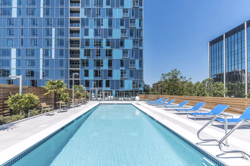 Relaxing outdoor pool with cabanas at One South Market Apartments