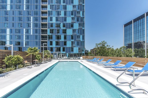 Relaxing outdoor pool with cabanas at One South Market Apartments