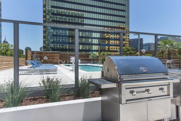 Grill stations at One South Market Apartments with sleek design and communal seating, ideal for outdoor gatherings in urban luxury living