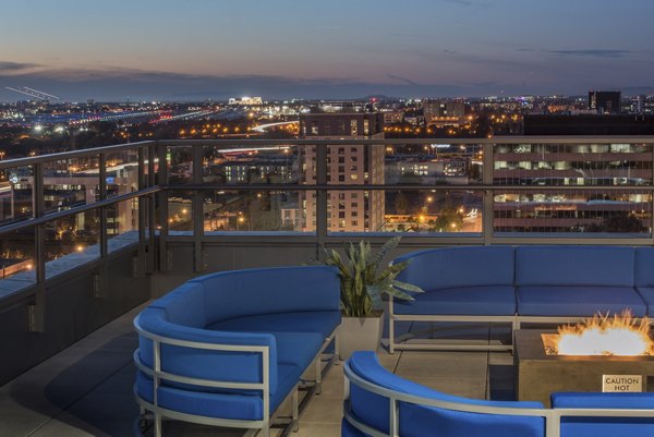 Outdoor fire pit lounge area at One South Market Apartments featuring cozy seating and city views