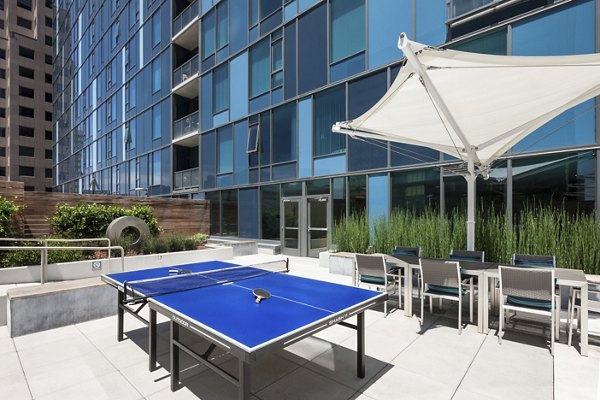 One South Market Apartments: Tranquil courtyard featuring lush greenery and seating areas in San Jose luxury community