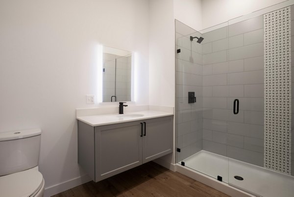 Luxurious bathroom featuring marble countertops and modern fixtures at Caldwell Apartments