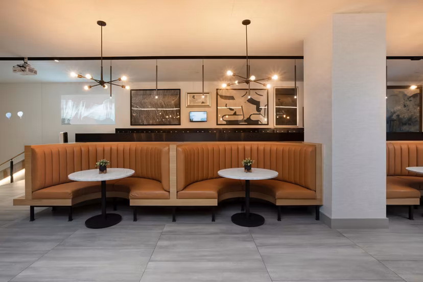 Clubhouse offering modern lounge and entertainment spaces at Caldwell Apartments, a Greystar luxury living community