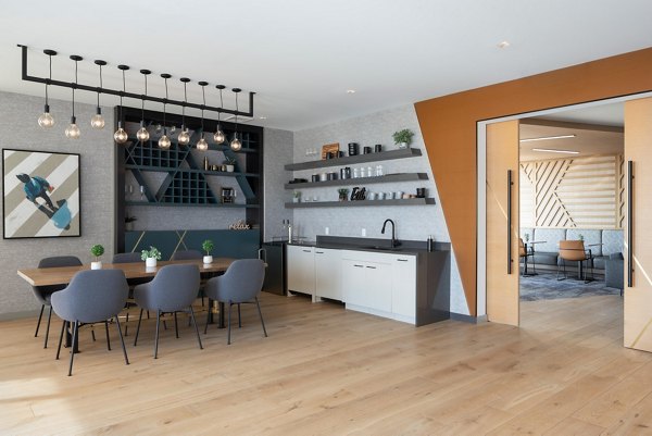 Clubhouse with modern furnishings and large windows at Caldwell Apartments, a Greystar luxury community