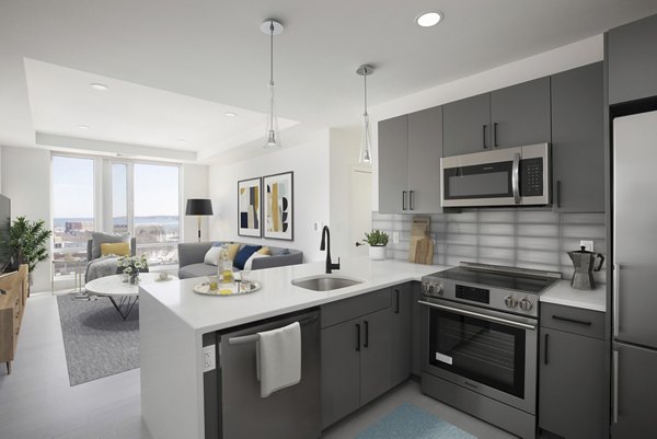 Sleek kitchen with stainless steel appliances in Caldwell Apartments, offering modern luxury living spaces