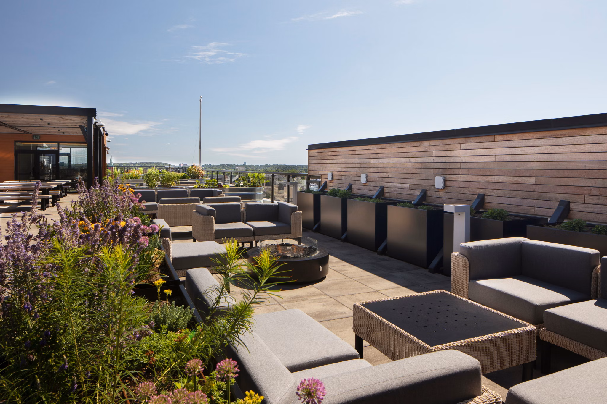 Outdoor fire pit and cozy seating on the patio at Caldwell Apartments