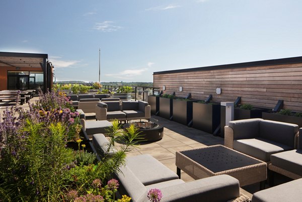 Outdoor fire pit and cozy seating on the patio at Caldwell Apartments