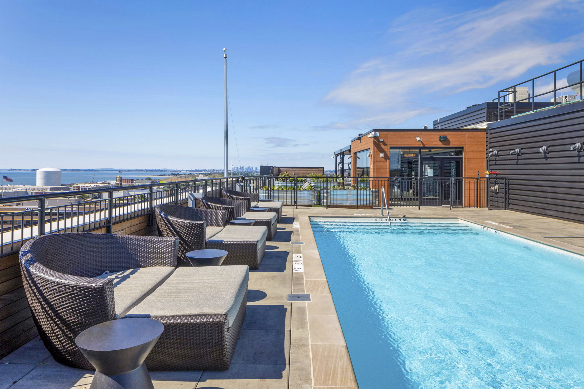 Chic outdoor pool area at Caldwell Apartments featuring comfortable lounge chairs and shaded spaces