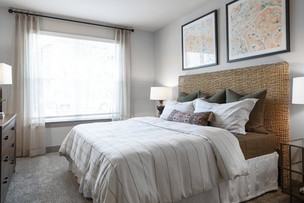 Bedroom with stylish decor and large windows at Broadstone Vintage Park Apartments: A luxury Greystar residence in a tranquil Houston setting