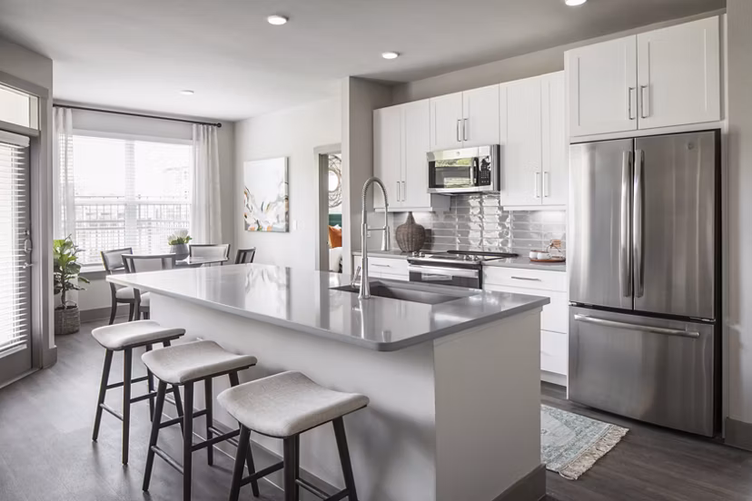 Modern kitchen with stainless steel appliances at Broadstone Vintage Park Apartments, featuring granite countertops and ample cabinet space