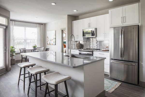 Modern kitchen with stainless steel appliances at Broadstone Vintage Park Apartments, featuring granite countertops and ample cabinet space