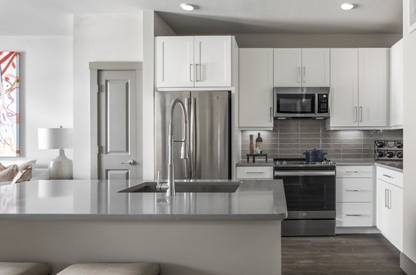 Modern kitchen with stainless steel appliances and granite countertops at Broadstone Vintage Park Apartments