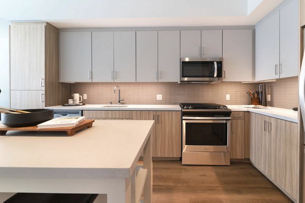 Sleek kitchen with marble countertops and stainless steel appliances at The Upper Ivy Apartments