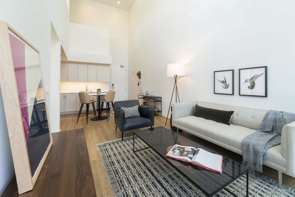 Spacious living room with elegant decor and natural light at The Upper Ivy Apartments