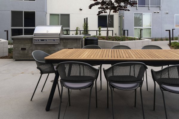 Outdoor grilling area with modern barbecue setup at The Upper Ivy Apartments, perfect for hosting gatherings and enjoying alfresco dining