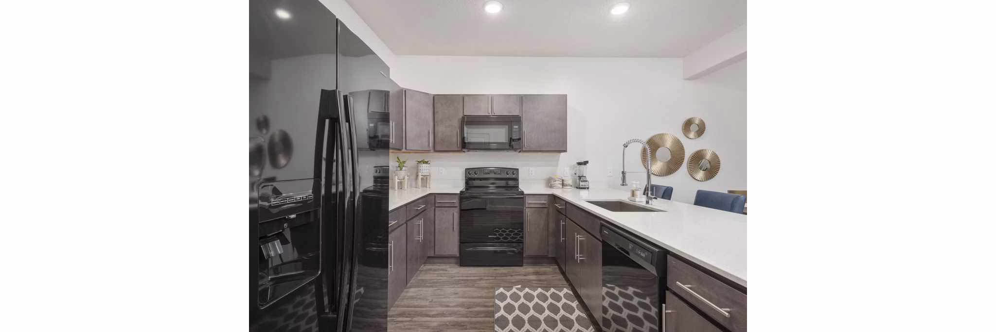 Modern kitchen featuring stainless steel appliances and granite countertops at Haven Dell Apartments