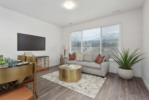 Living room featuring modern decor and large windows at Haven Dell Apartments