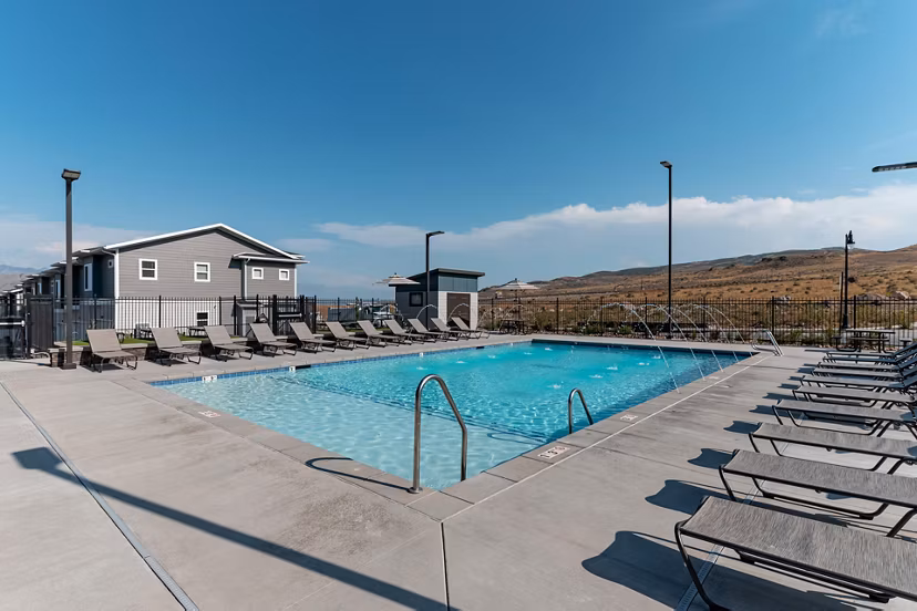 Sun-drenched outdoor pool at Haven Dell Apartments with lounge seating