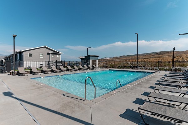 Sun-drenched outdoor pool at Haven Dell Apartments with lounge seating