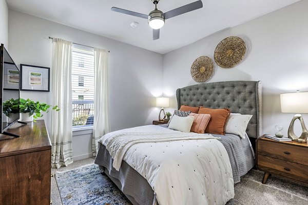 Bedroom with modern design and cozy decor in Album Benbrook Apartments