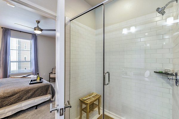 Modern bathroom featuring sleek fixtures and subway tile in Album Benbrook Apartments