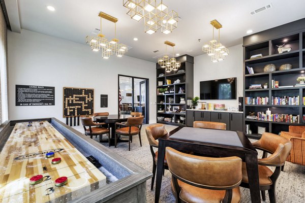 Game room with pool table and lounge area at Album Benbrook Apartments