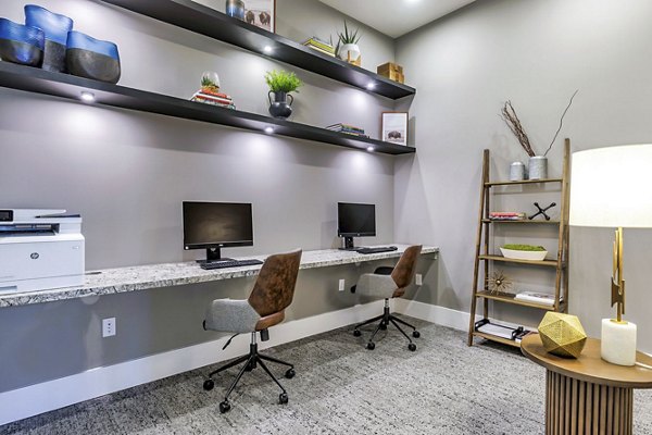 Clubhouse business center with workspace and computers at Album Benbrook Apartments, perfect for luxury apartment residents seeking productivity