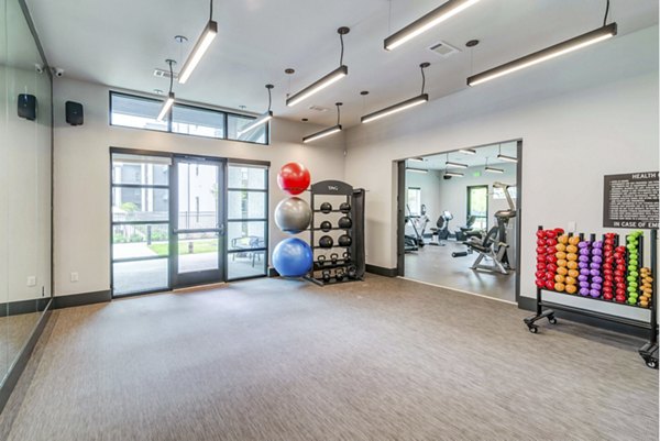 Modern fitness center with state-of-the-art equipment at Album Benbrook Apartments