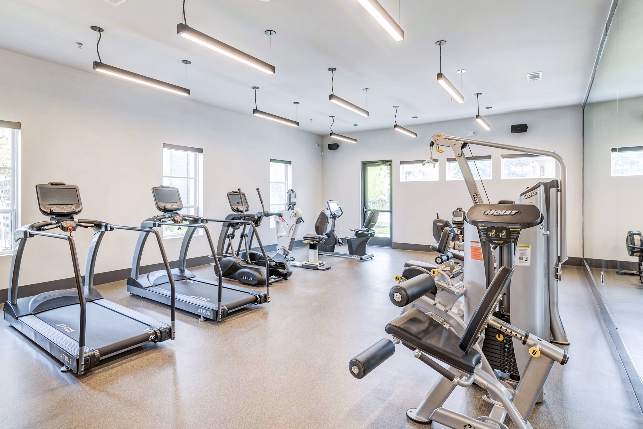 State-of-the-art fitness center at Album Benbrook Apartments with modern equipment