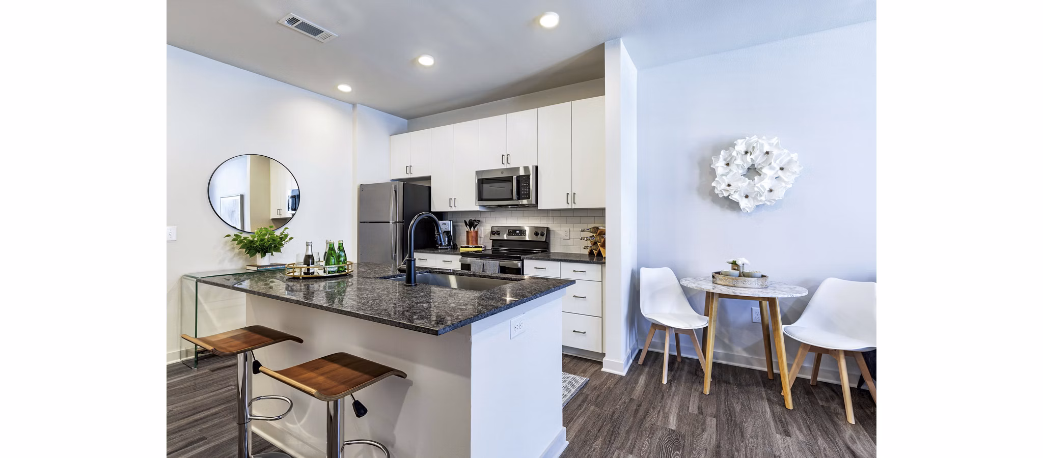 Modern kitchen with stainless steel appliances at Album Benbrook Apartments