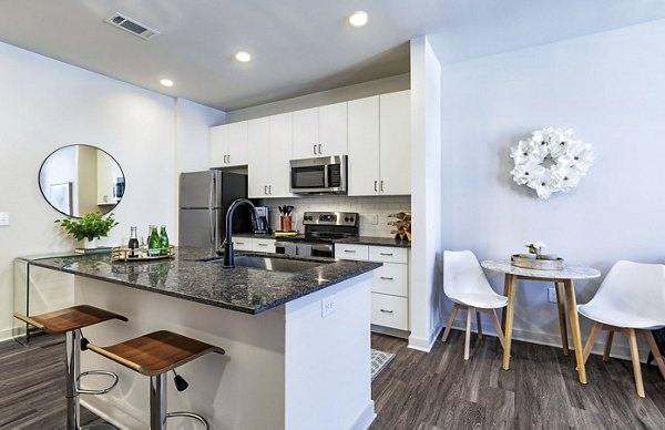 Modern kitchen with stainless steel appliances at Album Benbrook Apartments