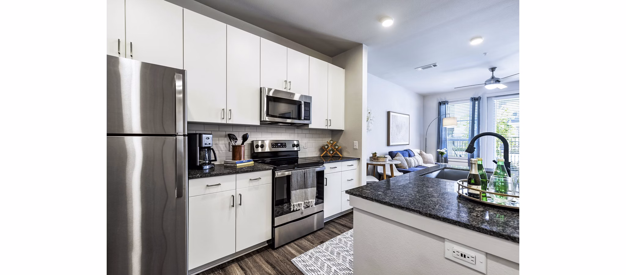Modern kitchen with stainless steel appliances at Album Benbrook Apartments