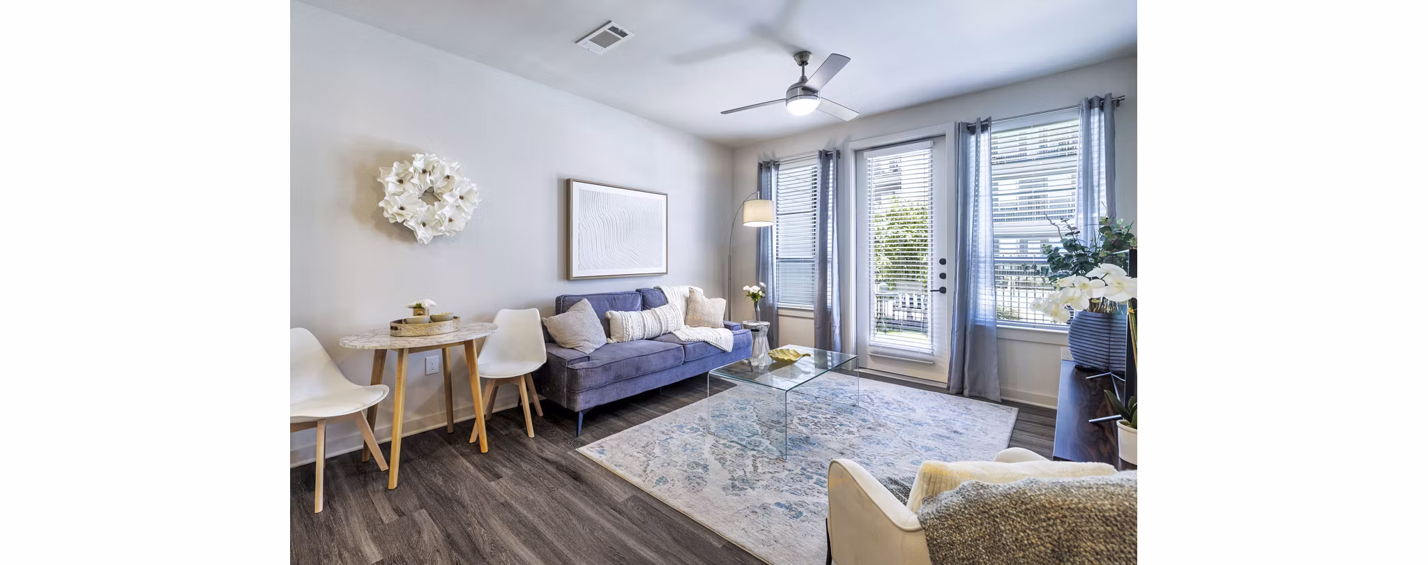 Living room with elegant decor and natural light at Album Benbrook Apartments