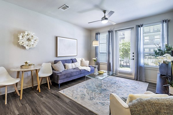Living room with elegant decor and natural light at Album Benbrook Apartments