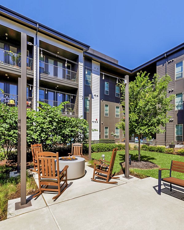 Cozy outdoor fire pit and seating area at Album Benbrook Apartments patio