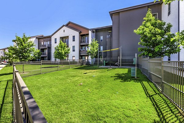 Dog park with agility equipment at Album Benbrook Apartments