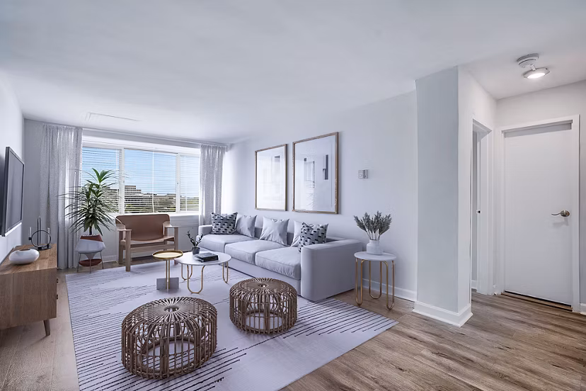 Spacious living room with modern decor in Potomac Towers Apartments