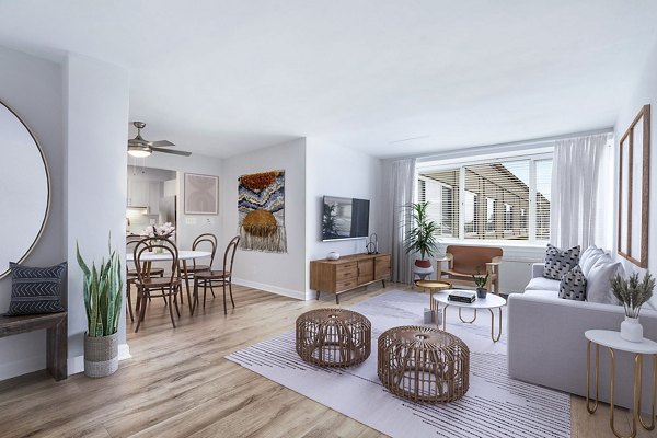 Modern living room with cozy seating and natural light at Potomac Towers Apartments in Arlington