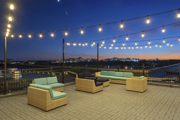 Cozy patio with seating and beautiful views at Potomac Towers Apartments, ideal for relaxation and enjoying outdoor living spaces