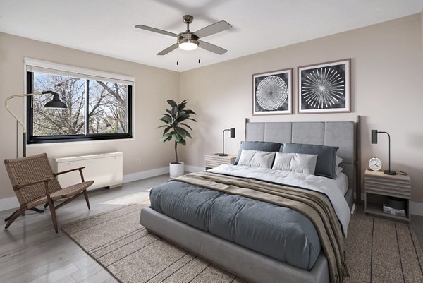 Elegant bedroom featuring a cozy king-size bed and modern decor in Shawnee Apartments
