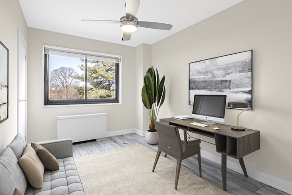 Den featuring cozy seating and modern decor in Shawnee Apartments