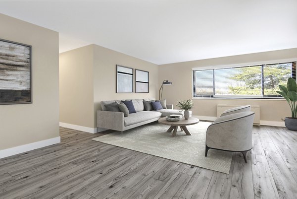 Spacious living room with contemporary decor in Shawnee Apartments, showcasing luxury living at its finest