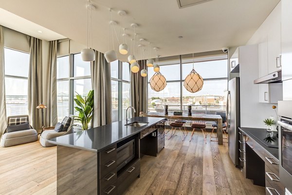 Elegant clubhouse with modern decor at Boston East Apartments, offering upscale social spaces and community events in luxury waterfront living