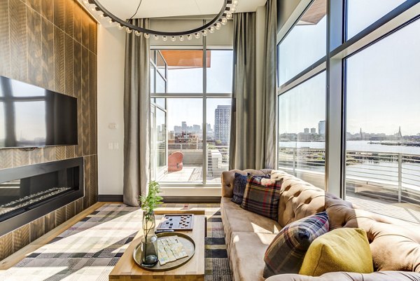Clubhouse featuring modern seating and large windows at Boston East Apartments in luxury living community