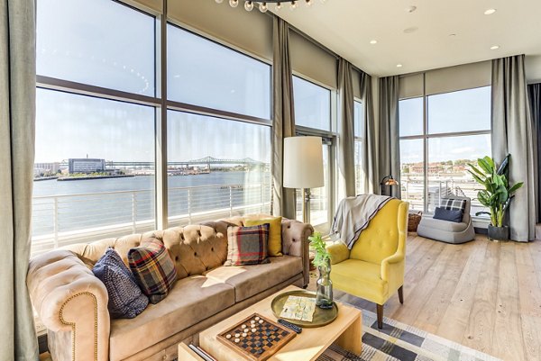 Community clubhouse featuring modern design at Boston East Apartments, offering a social space in luxury waterfront living