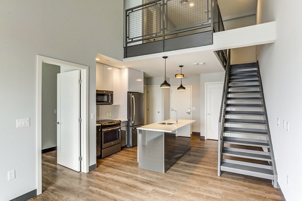 Modern kitchen with stainless steel appliances in Boston East Apartments, offering luxury living in the heart of Boston's waterfront district
