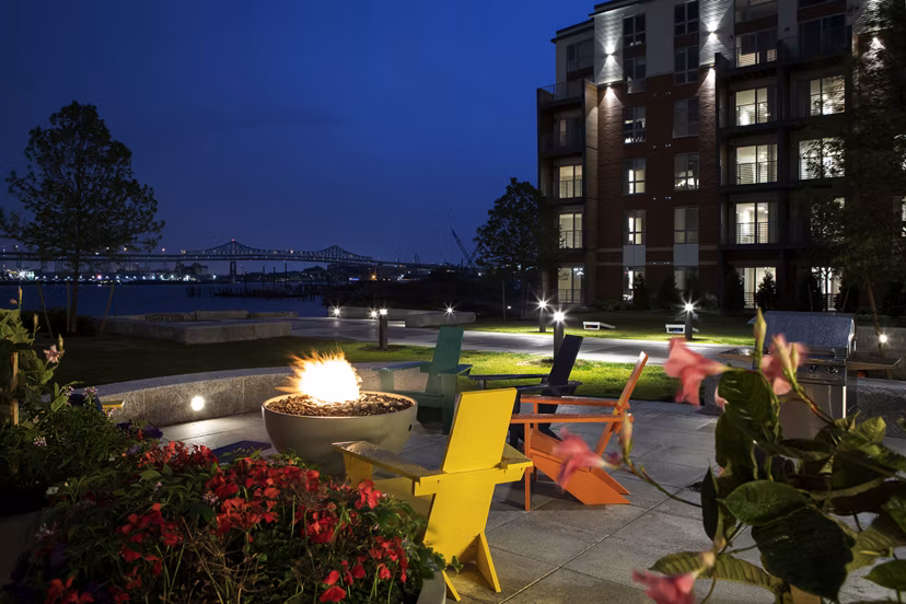 Inviting outdoor fire pit area with plush seating at Boston East Apartments, nestled in the vibrant waterfront district of Boston
