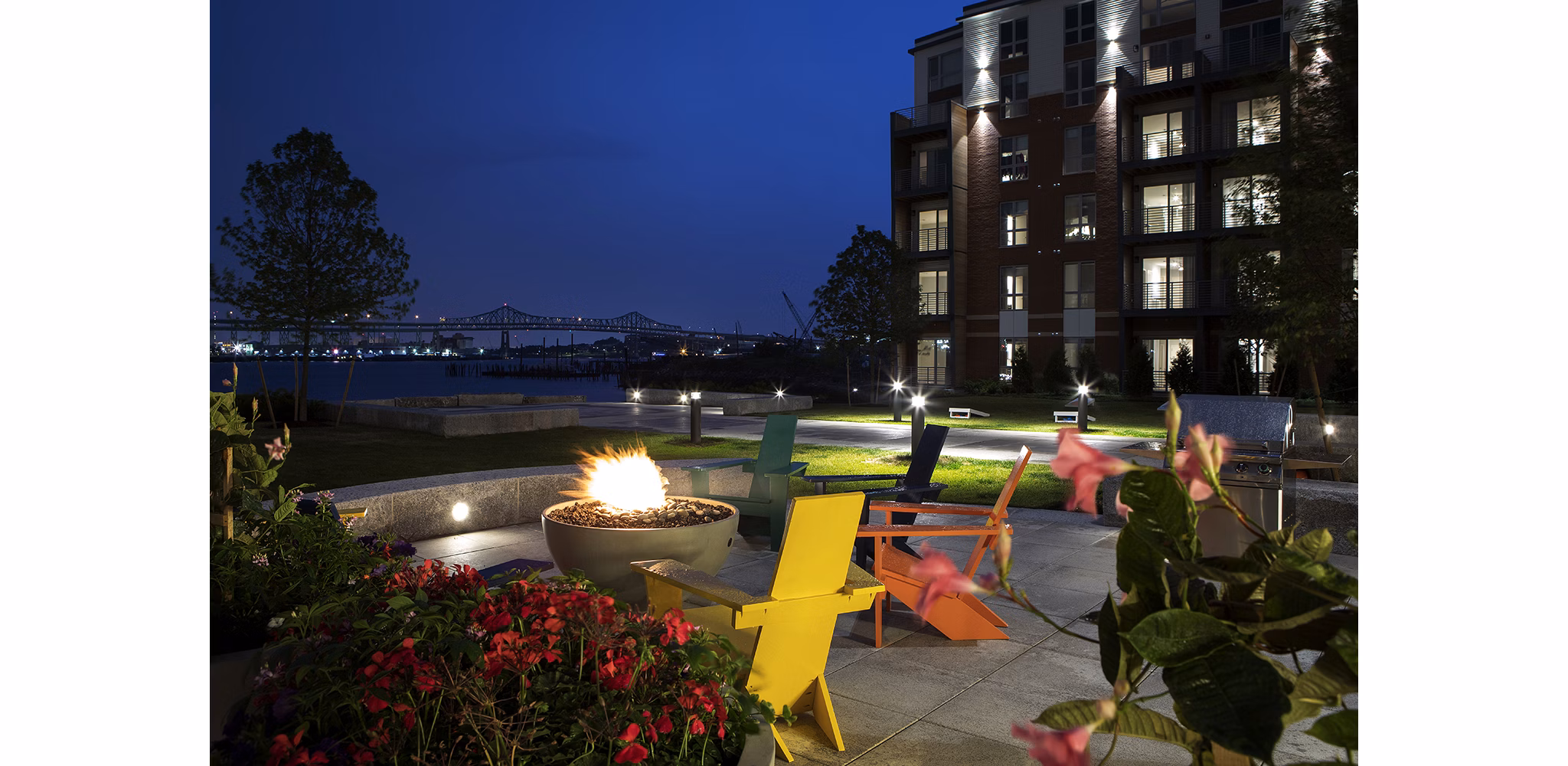 Inviting outdoor fire pit area with plush seating at Boston East Apartments, nestled in the vibrant waterfront district of Boston