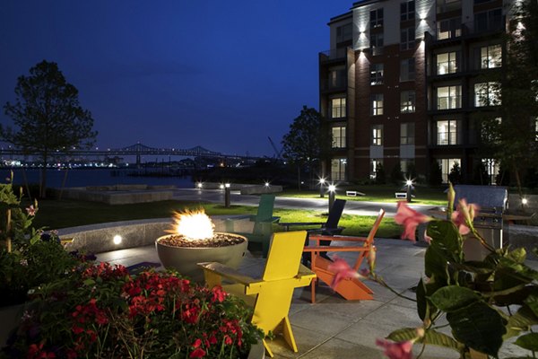Inviting outdoor fire pit area with plush seating at Boston East Apartments, nestled in the vibrant waterfront district of Boston