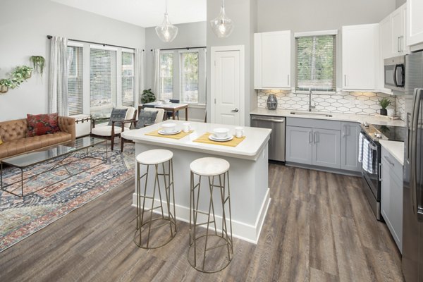 Modern kitchen with stainless steel appliances and granite countertops in Broadstone Trailside Apartments